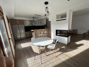 a kitchen with a table and chairs in a room at Hostal Rural Sartaguda in Sartaguda