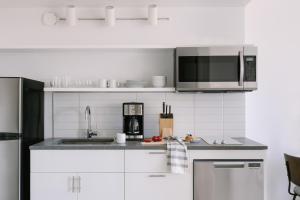 a kitchen with a sink and a microwave at Sonder Court Square in Long Island City