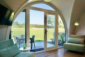 a living room with a sliding glass door with a patio at EASTRIDGE GLAMPING in Shrewsbury