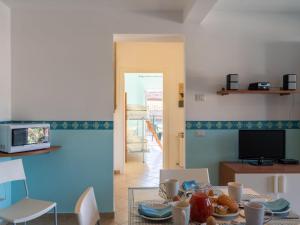 a living room with a table with food on it at Apartment Verde - PTB151 by Interhome in Pietrabuona