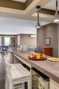 a kitchen with a counter with a bowl of fruit on it at VESTA Nile View Residence - Maadi in Cairo +6 photos