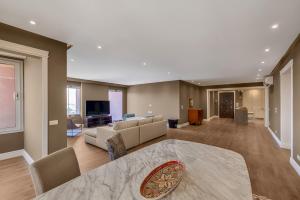 a large living room with a couch and a tv at VESTA Nile View Residence - Maadi in Cairo