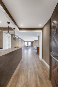an open kitchen and living room with wood floors at VESTA Nile View Residence - Maadi in Cairo