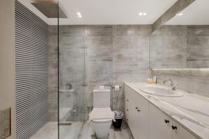 a bathroom with a toilet and a sink at VESTA - Nile View Residence in Cairo +26 photos