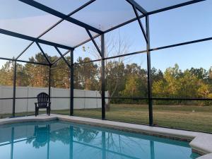 a screened in pool with a chair next to it at Sruthan Kerith in Davenport