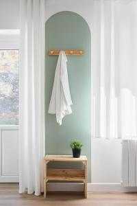 a room with white curtains and a table and a window at Le Duplex in Saint-Nicolas-de-Redon