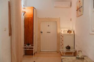 a room with a hallway with a door and a table at Houch ZanZouri in Houmt Souk +28 photos