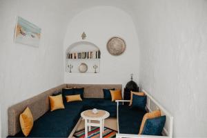 a living room with a couch and a table at Houch ZanZouri in Houmt Souk