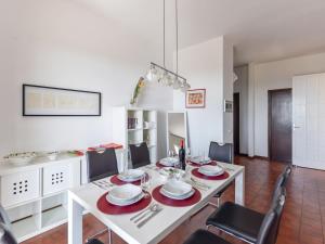 a dining room with a white table and chairs at Holiday Home Incantevole by Interhome in Soiano del Lago