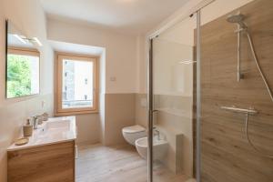 a bathroom with a shower and a toilet and a sink at Al Campanile - Valtellina - 15 min da Bernina Express in Grosotto
