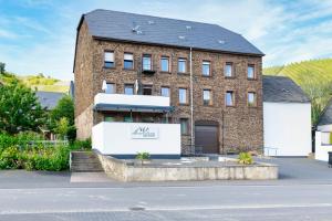 a large brick building with a sign on it at VonMos Moselblick Apartments in Kinheim