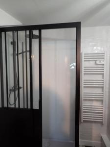 a glass door leading into a room with at Maison type Loft - avec parking en plein centre in La Rochelle +16 photos