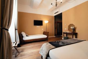 a hotel room with a bed and a couch at NAMAN HOTELLERIE - Monti in Rome