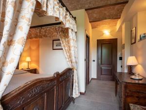 a bedroom with a canopy bed in a room at Holiday Home General Massena - NAZ110 by Interhome in Bene Vagienna +8 photos