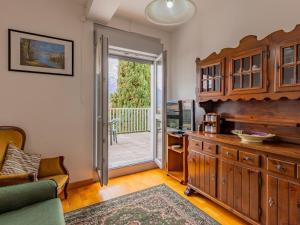 a living room with a door leading to a patio at Apartment Assunta by Interhome in Stazzona