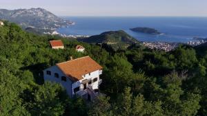 a house on a hill with the ocean in the background at Villa Concordia in Budva