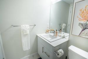 a white bathroom with a sink and a mirror at Warm getaway Perfect for 4 in Edmonton