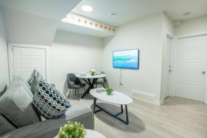 a living room with a couch and a table at Warm getaway Perfect for 4 in Edmonton