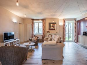 a living room with couches and chairs and a tv at Holiday Home Cascina-2 by Interhome in Costigliole dʼAsti