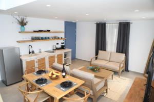 a kitchen and living room with a table and chairs at White Dream Suites Antiparos in Antiparos
