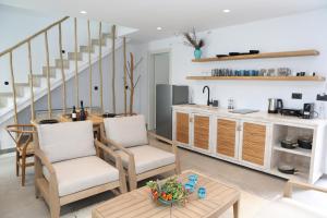 a kitchen and living room with a table and chairs at White Dream Suites Antiparos in Antiparos