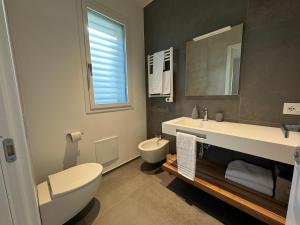 a bathroom with a toilet and a sink and a mirror at B&B Room47 in Alba Adriatica +19 photos