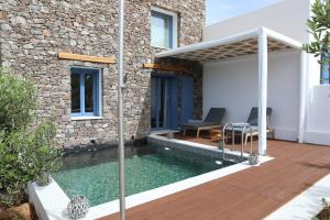 a swimming pool in the backyard of a house at White Dream Suites Antiparos in Antiparos