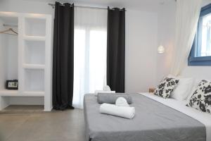 a bedroom with a bed with two towels on it at White Dream Suites Antiparos in Antiparos