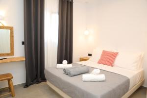 a bedroom with a bed with towels on it at White Dream Suites Antiparos in Antiparos