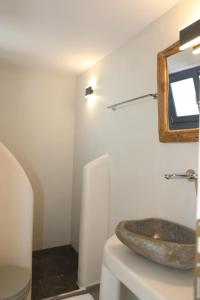 a bathroom with a sink and a mirror on the wall at White Dream Suites Antiparos in Antiparos