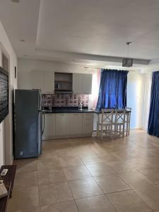 a kitchen with a refrigerator and a counter top at Serene Selena Bay Apartments in Hurghada