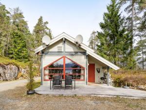 a small house with a porch and chairs on a deck at Holiday Home Veganeset II by Interhome in Balestrand +29 photos