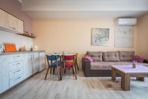 a living room with a couch and a table at Boulevard Apartments in Gevgelija