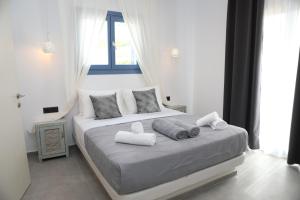 a bedroom with a bed with towels on it at White Dream Suites Antiparos in Antiparos