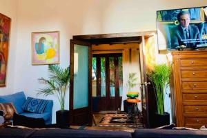 a living room with a blue couch and a dresser at La Pajarera prime location in San Miguel in San Miguel de Allende