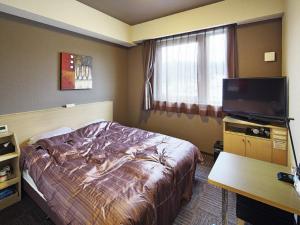 Tempat tidur dalam kamar di Hotel Route-inn Yaita