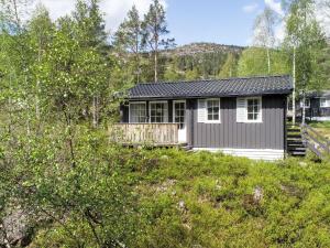 a small house on a hill in the woods at Chalet Thorabu by Interhome in Øyuvstad