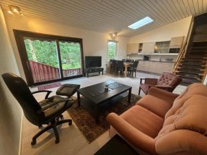 a living room with a couch and a table at Fint parhus in Falkenberg