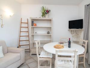 a living room with a white table and chairs at Apartment Timo by Interhome in Casa Tamponi