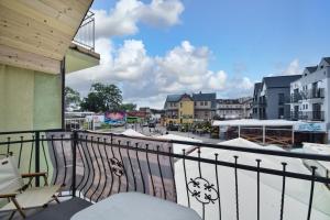 a balcony with a view of a city at Apartamenty Przy Bałtyckiej in Mrzeżyno