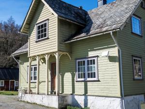 an old green and white house with a roof at Holiday Home Greenhouse by Interhome in Onarheim