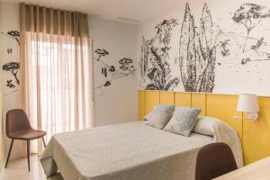 a bedroom with a bed with a yellow headboard at Casa para 8 personas con jardin in Palafolls +84 photos
