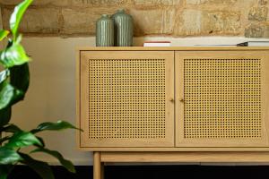 a wooden cabinet with a wicker door at Villa Del Lauro in Ragusa