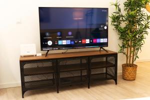 马德里Bravo Murillo Apartment的黑色娱乐中心顶部的平面电视