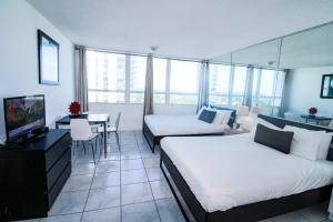 Habitación de hotel con 2 camas, mesa y TV en Castle 1118 Studio BayView Direct Beach Access, Tennis, Pool, Restaurants, Free Parking, en Miami Beach 36 fotos más