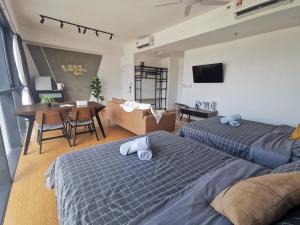 a living room with two beds and a dining room at Harmonee Homes at The Hub SS2, PJ in Petaling Jaya