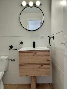 a bathroom with a sink and a mirror at Apartamento Indalo en primera linea de playa in Las Negras