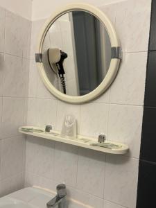 a bathroom with a mirror and a sink at HÖTEL U SANTA MARIA in Olmeto