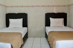 Letto o letti in una camera di Garuda Setia Hotel