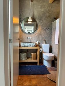 a bathroom with a sink and a mirror at Amélia's House (Casa das Amélias) in Grândola